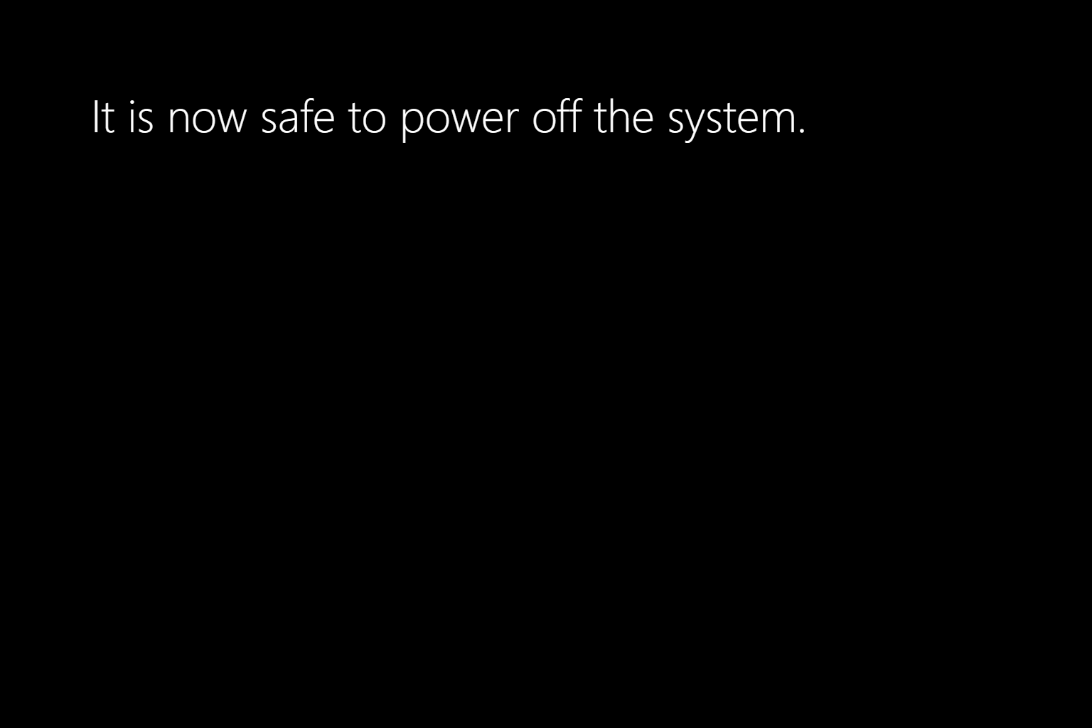 It is now safe to power off the system. The version in Windows 10 in English. Text in Segoe UI and white, at upper-left corner of the screen.
